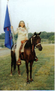 Alyse riding Dream Catcher carrying the Youth Flag